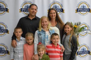 Family in front of PYLUSD step and repeat.