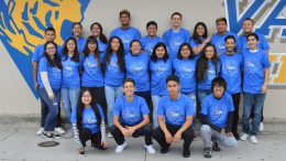 Valencia High School AVID seniors pose for a picture by the school's mural.