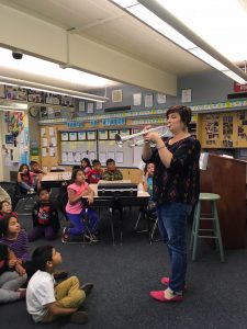 Mrs. Brenes playing a french horn at Ruby Drive Elementary.