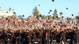 El Dorado High School graduates throwing their caps.