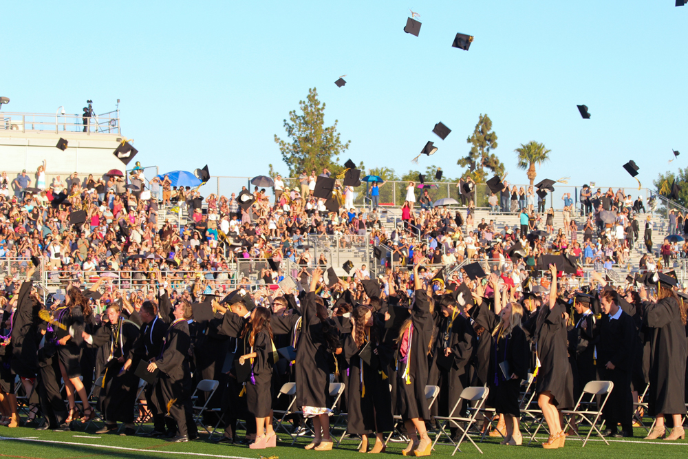 El Dorado High School graduates throwing their caps.