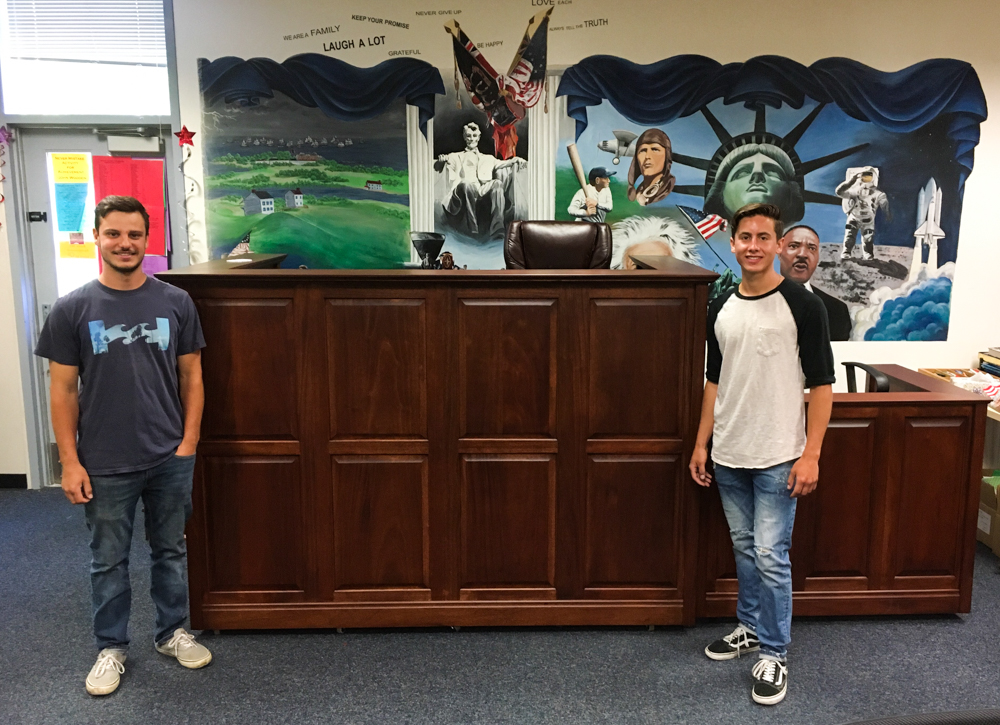 Carpentry students at El Dorado standing in front of their courtroom furniture project.