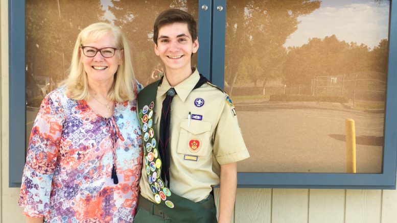 Parkview Eagle Scout pictured with his principal and new announcement cabinet on campus.