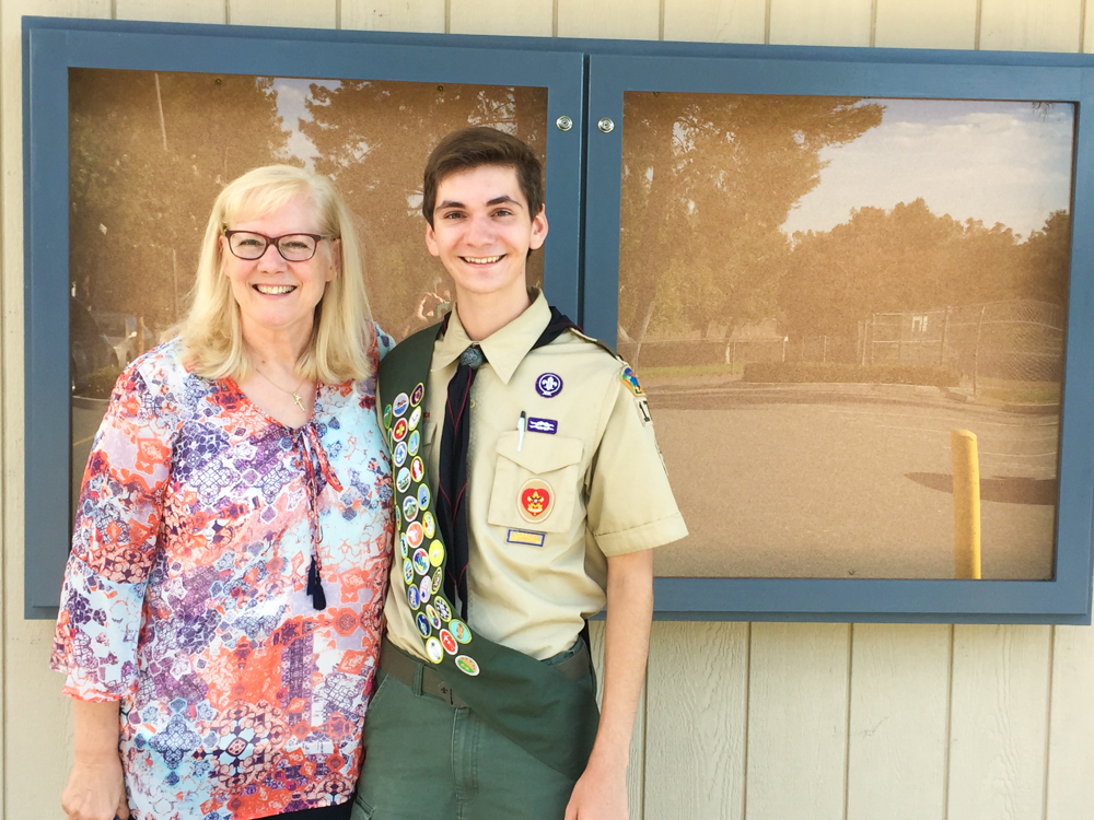 Parkview Eagle Scout pictured with his principal and new announcement cabinet on campus.