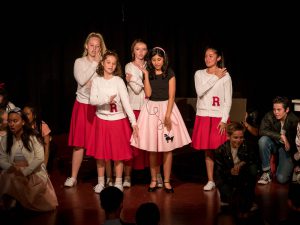 BYMS performing Grease on stage.