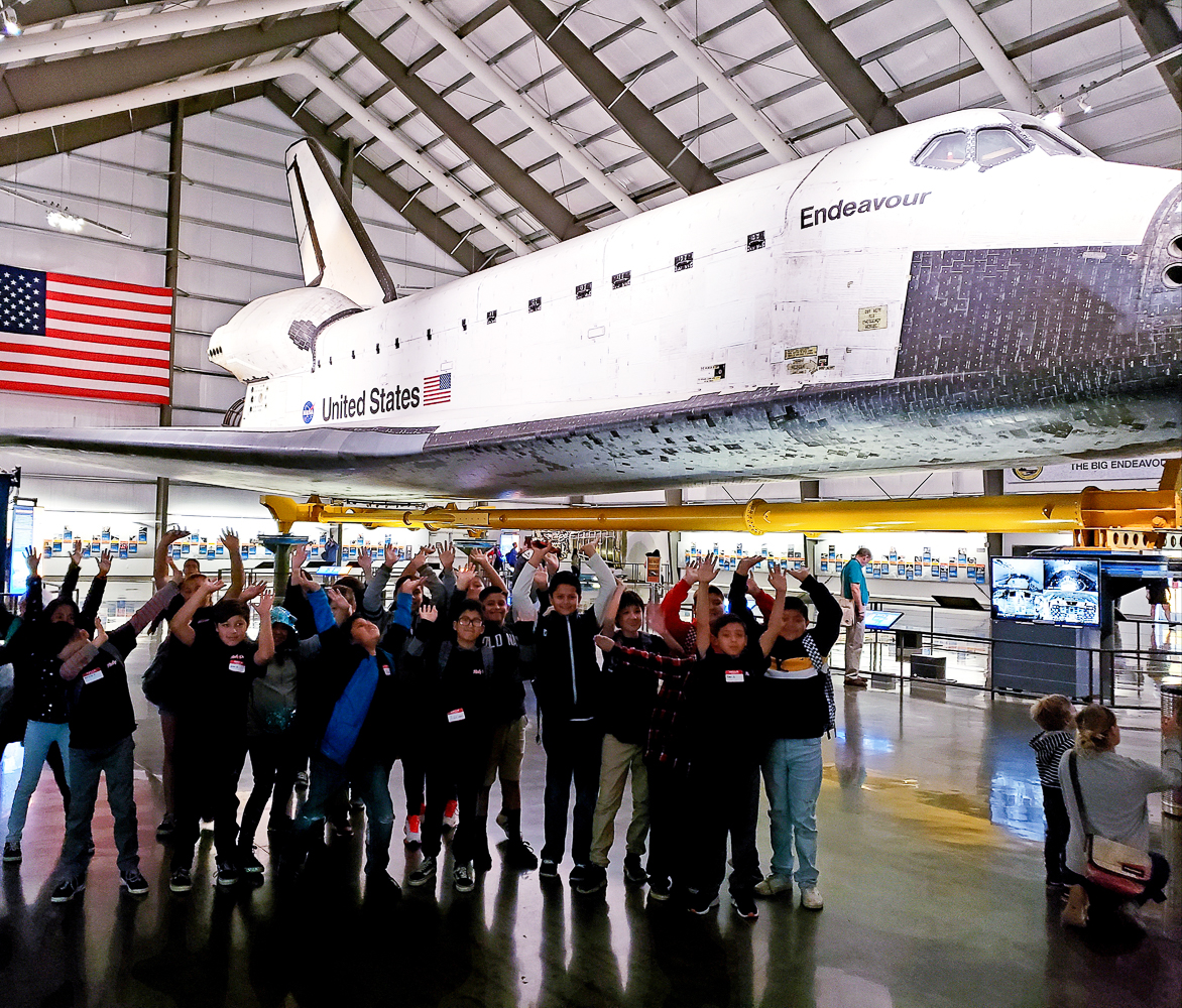 Ruby Drive students pose for a photo in front of the Space Shuttle Endeavour.