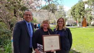 From left to right, Rick Lopez, Assistant Superintendent of Human Resources, Candy Plahy, Deputy Superintendent, and Carrie Buck, Board President, hold the award presented to PYLUSD for full secondary participation in the contest.