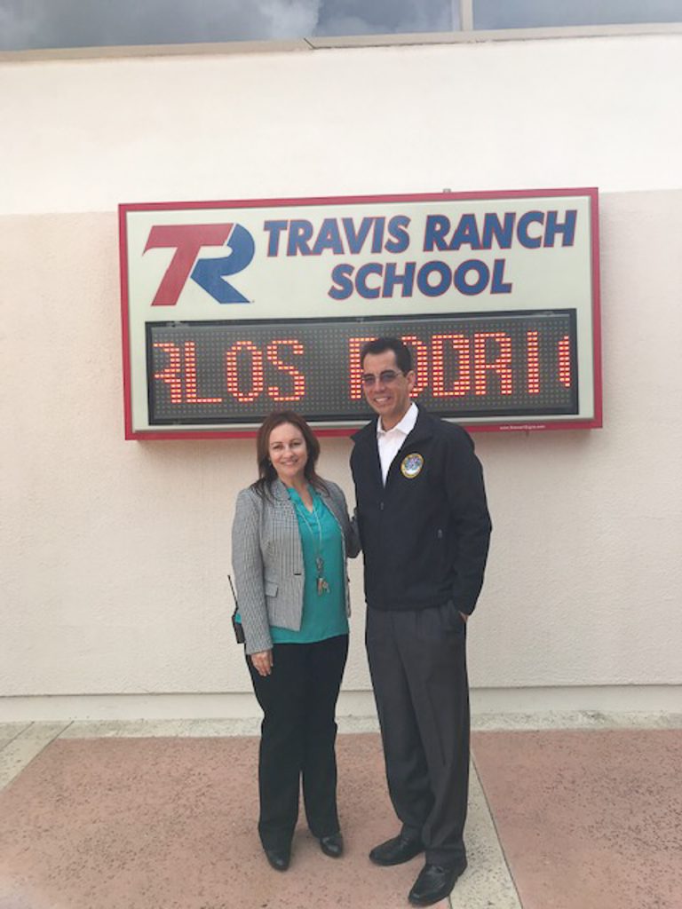 Travis Ranch School's Principal for a Day, Carlos Rodriguez, and Principal Susan Metcalf.