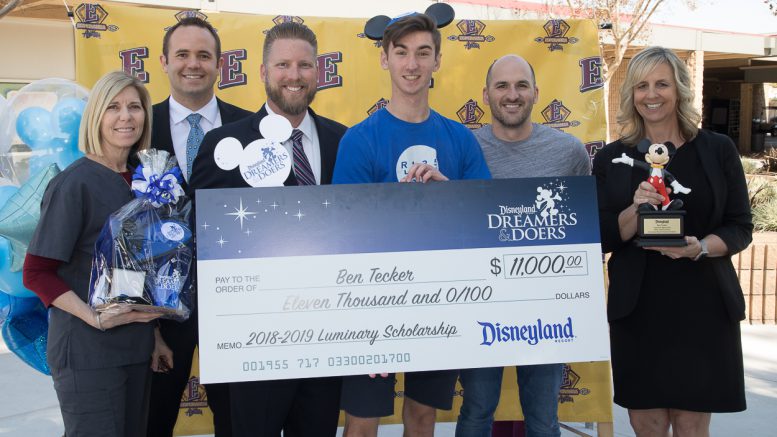 With his Mickey Mouse ears proudly on, Ben poses for a picture with his $11,000 college scholarship check and (left to right) Esperanza counselor, Brianne Gullotti, assistant principals, Connor Drake and Scott Mazurier, teacher, Brent Willis, and principal, Gina Aguilar. Ben had just received the news that he was selected as a 2018-19 Disneyland Resort Dreamers & Doers Program Luminary!