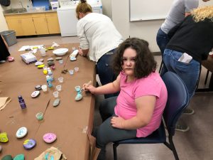 George Key students painting rocks with community partners.