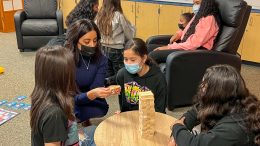 Wellness Specialist Yvette Kettering plays a game of question-and-answer Jenga with students in Valadez Middle School Academy's new Wellness Center.