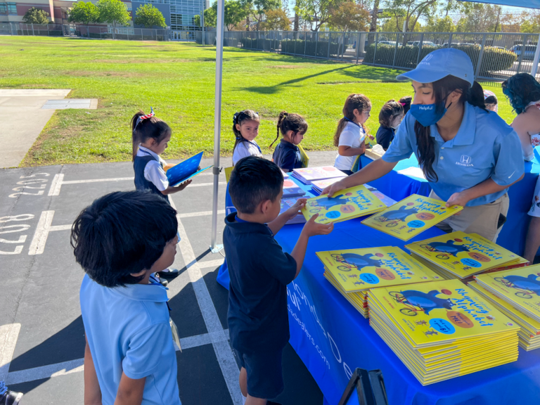 Melrose Elementary School students receive books from Helpful Honda People