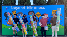 Club students making donation to Beyond Blindness.