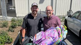 Community members drop off backpacks with school supplies.
