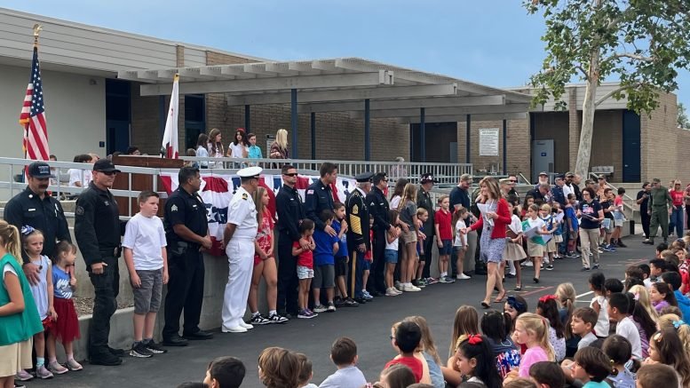 Heroes and students participate in the ceremony.