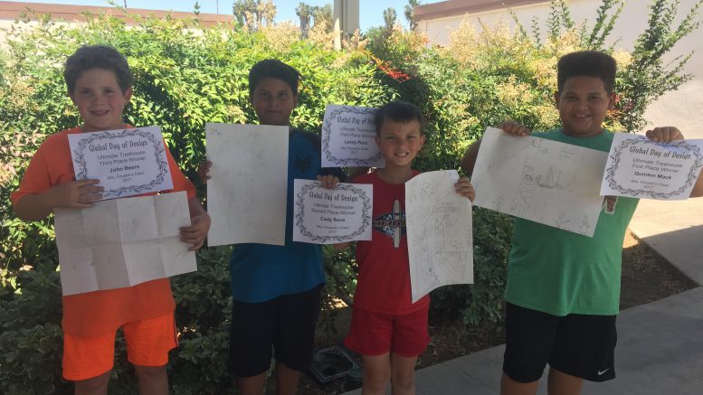 Boys hold up Global Day of Design certificates.