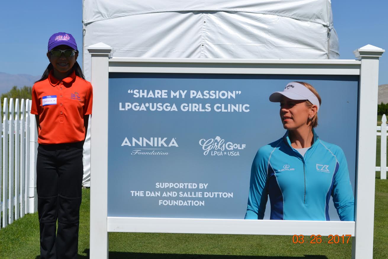 Gabrielle Mercado standing next to golf sign.