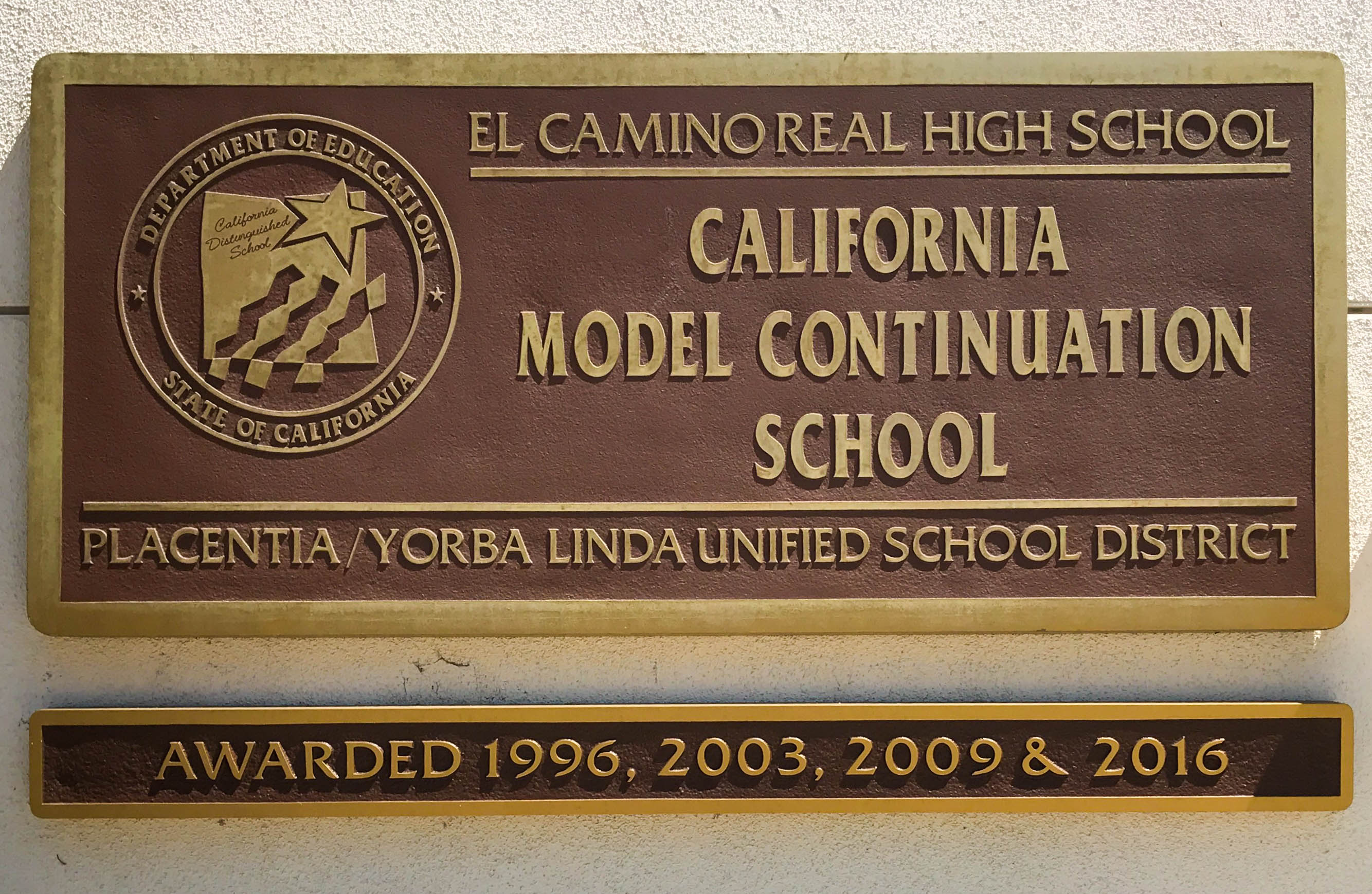El Camino Real High plaque on the front of the high school.