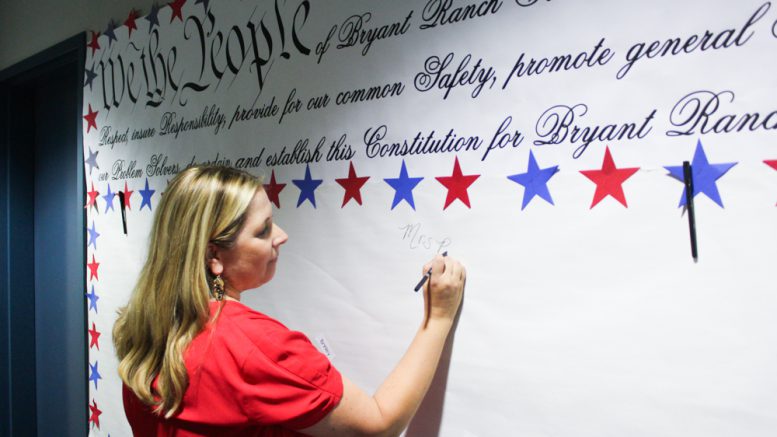 Bryant Ranch School principal, Dominique Polchow, signs the Bryant Ranch Constitution along with students in honor of Constitution Day.
