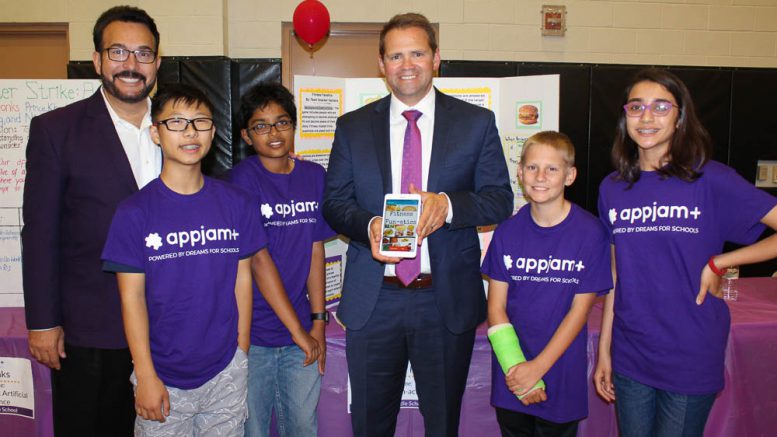 Principal Keith Carmona and teacher Shane Twamley pose with Kraemer Middle School's AppJam+ team, Snacker Hackers, in the El Dorado High School gymnasium. Later that evening, Team Snacker Hackers won first place in PYLUSD's AppJam+ Spring 2018 Showcase Finale!