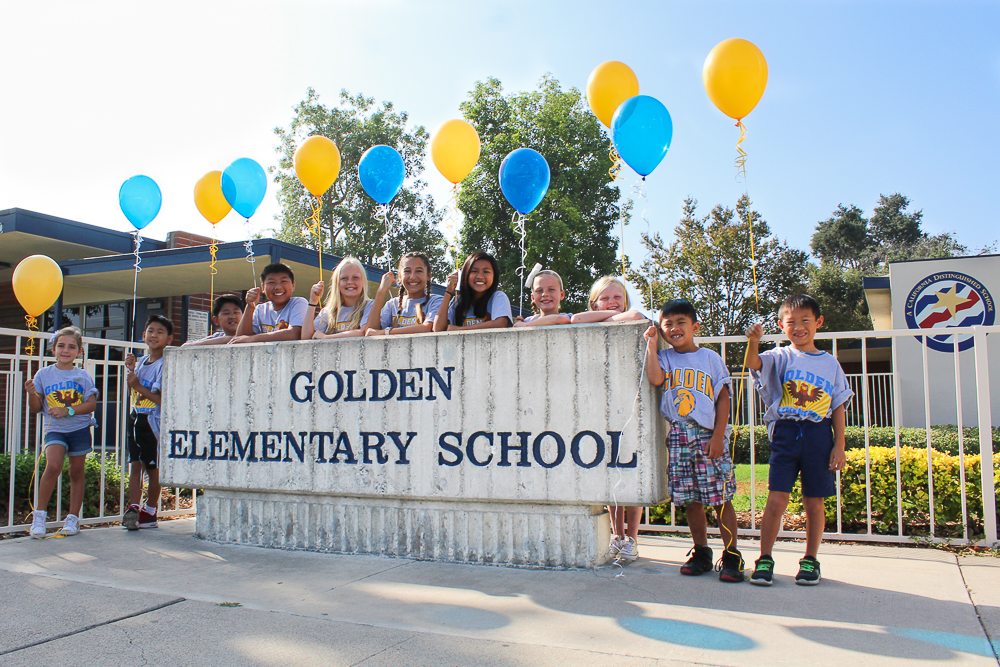Golden Elementary School students standing in front of their school.