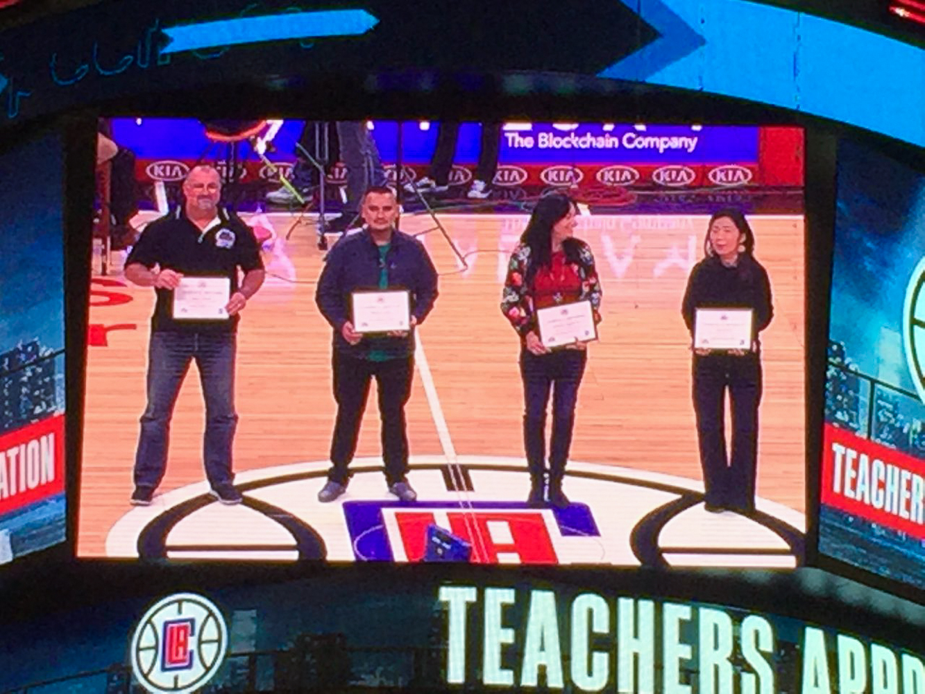 El Camino Real High School teacher, Jason Sweet, is shown on the jumbo-tron during a special pre-game ceremony at the Los Angeles Clippers game on December 28, 2018.