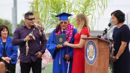 Upon the stage at the 50 yard line in Bradford Stadium, Mr. Filiberto Lopez Montano receives high long-awaited high school diploma from Board President, Carrie Buck, and Valencia High School Principal, Olivia Yaung on Friday, June 7, 2019.