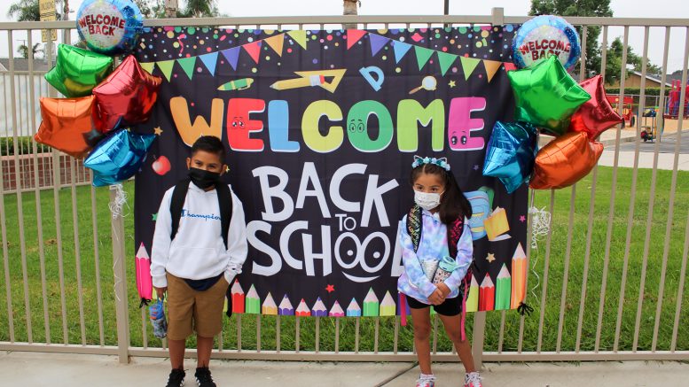 Students pose for a picture on the first day of school at Ruby Drive Elementary School.
