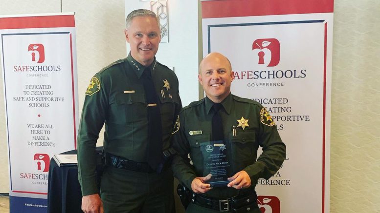 Deputy Nick Doty is pictured with OC Sheriff Don Barnes after receiving his Distinguished Safe Schools Award at the 12th annual Safe Schools Conference in Garden Grove.